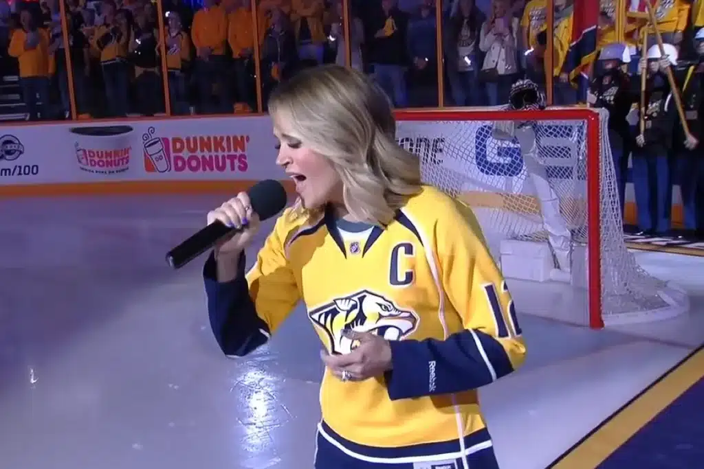 Carrie Underwood wowed Bridgestone Arena with a powerful National Anthem before Game 3 of the Stanley Cup Playoffs. Her deep ties to Nashville, as a Grammy-winning artist and wife of Predators’ captain Mike Fisher, made the emotional moment unforgettable for both fans and players.