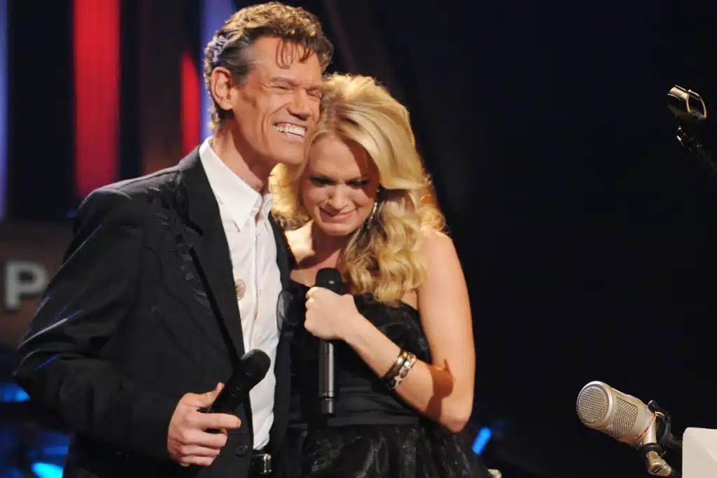 Seventeen Years Ago, Randy Travis Stepped on Stage, the Spotlight Hit, the Crowd Held Its Breath—Then He Asked Carrie Underwood the Question That Changed Her Life Forever.