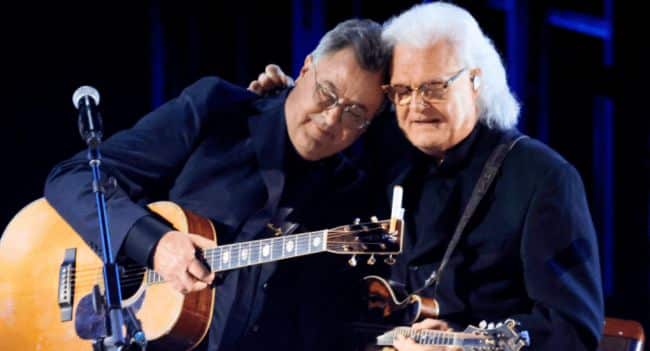 Vince Gill Took the Mic at the Opry, Asked Everyone to Remember Those They’ve Lost, Dedicated Go Rest High on That Mountain to His Nearly 100-Year-Old Mother, and Hit Harder When He Said “This Is About Her Son,” Turning the Song into Pure Grief and Love You Could Feel in Every Note