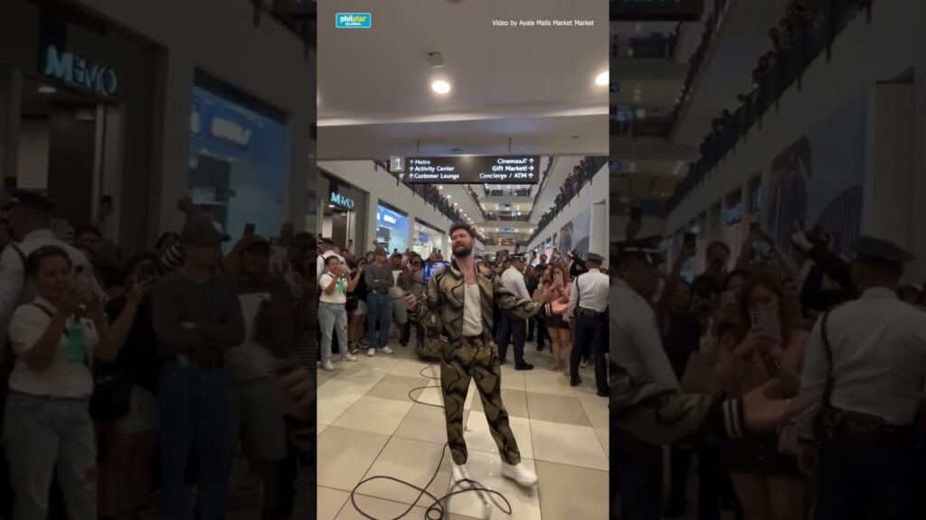 “NO ONE EXPECTED THIS — AND FOR 3 MINUTES, THE MALL FORGOT HOW TO BREATHE.” An ordinary afternoon at Ayala Malls Market! Market! suddenly turned unreal when Calum Scott casually stepped up and began singing “You Are The Reason.” No stage. No warning. Just that unmistakable voice cutting through the noise — and everything else stopped. Conversations faded. Shoppers froze mid-step. Phones shot into the air as people realized this wasn’t a recording… this was him. As the song built, you could feel the emotion ripple through the crowd — strangers standing shoulder to shoulder, some smiling, some wiping their eyes. And when the final note landed, the mall didn’t erupt right away… it exhaled, then burst into applause. A random day became a once-in-a-lifetime memory — the kind people will swear they were there for.